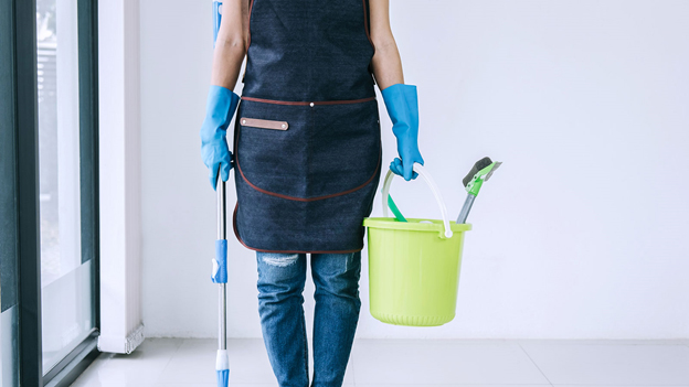 a person holding cleaning material while standing